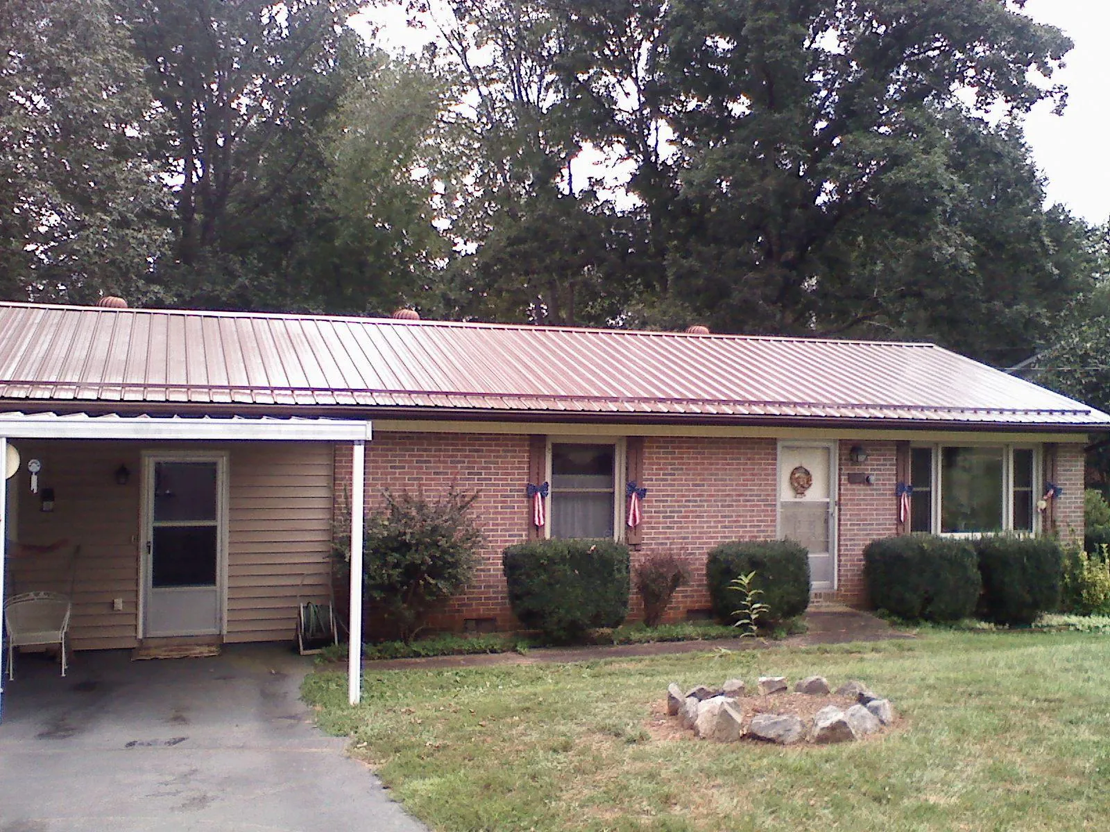 Bronze metal roof and carport on a brick ranch home — Roof Repair work by our crew in Newburg